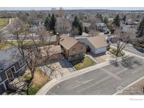 Charming home with mature trees, two-car garage and private driveway in established neighborhood at 373 Fir Ln, Broomfield, CO 80020