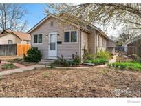 Charming single-story home featuring neutral siding, well-kept landscaping and a welcoming front door with a glass accent at 6058 S Hill St, Littleton, CO 80120