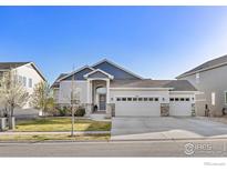 Charming single-Gathering home featuring a three-car garage, stone accents, and well-maintained landscaping at 675 Lene Ln, Berthoud, CO 80513