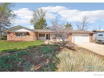 Charming single-story brick home featuring a well-manicured lawn and a two-car garage at 803 Laurel Ave, Boulder, CO 80303
