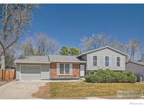 Charming home with brick and siding, a well-manicured lawn, and a two-car garage at 907 Stein St, Lafayette, CO 80026