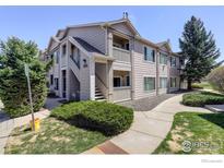 Inviting condo exterior featuring a private balcony and well-maintained landscaping at 1016 Opal St # 102, Broomfield, CO 80020