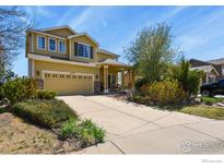 Charming two-story home with a brick-accented garage and well-manicured front yard at 11470 Ebony St, Firestone, CO 80504