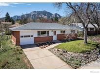 Charming single-story home featuring brick accents, an attached garage, and beautiful mountain views at 1275 Berea Dr, Boulder, CO 80305