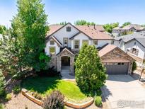 Beautiful two-story home featuring a landscaped front yard and a two-car garage at 1521 Orion Pl, Longmont, CO 80504