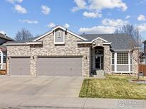Charming single-Gathering home featuring a three-car garage and a well-manicured lawn at 1536 Goshawk Dr, Longmont, CO 80504