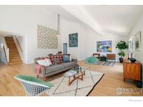 Bright living room with vaulted ceilings, wood floors, modern furnishings and unique decor at 1707 Grape Ave, Boulder, CO 80304