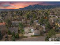 Panoramic aerial view of a home with mountain backdrop and colorful sunset at 1780 Redwood Ave, Boulder, CO 80304