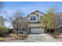 Charming two-story home featuring manicured landscaping and a welcoming front porch in a suburban neighborhood at 1865 Trevor Cir, Longmont, CO 80501