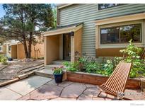 Inviting front exterior featuring a quaint patio area and a well-maintained yard with a charming wood chair at 2728 Northbrook Pl, Boulder, CO 80304