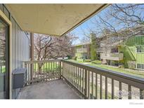 Balcony view overlooking the common area with blooming trees and pathway at 2800 Kalmia Ave # C212, Boulder, CO 80301