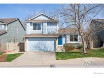 Charming two-story home with an attached garage and well-maintained front lawn at 3032 W Yarrow Cir, Superior, CO 80027