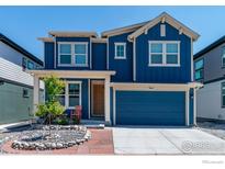 Beautiful two-story home with blue siding, attached garage, and a well-manicured front yard at 364 Shawnee Ln, Superior, CO 80027