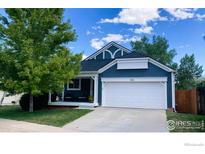 Charming single-Gathering home showcasing a well-manicured lawn and a two-car garage at 506 Entrada Dr, Golden, CO 80401