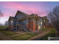 Inviting exterior of a multi-unit complex featuring well-maintained landscaping and classic architectural details at 804 Summer Hawk Dr # 3205, Longmont, CO 80504