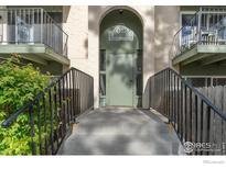 Inviting building entrance with wrought iron railings and a well-maintained walkway at 12113 Melody Dr # 104, Denver, CO 80234