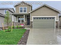 Charming two-story home with a well-maintained front yard and inviting covered porch at 15 Chipeta Way, Lochbuie, CO 80603