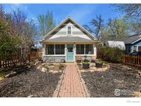 Charming home featuring a well-manicured front yard with a quaint walkway and seating area at 1830 9Th Ave, Longmont, CO 80501