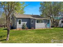 Charming single story home with well maintained front yard and a welcoming blue door at 285 Holbrook St, Erie, CO 80516