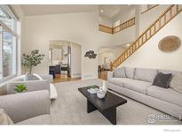 Open concept living room featuring a staircase and views to kitchen at 4575 Maple Ct, Boulder, CO 80301