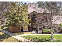 Charming brown townhome with well-maintained lawn and walkway leading to the entrance at 6251 Willow Ln, Boulder, CO 80301