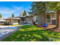 Modern home with a circular driveway and mature landscaping creating an inviting curb appeal at 6923 Hunter Pl, Boulder, CO 80301