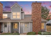 Charming townhome featuring a brick chimney, fresh paint, and well-maintained landscaping at 8265 W 90Th Pl, Westminster, CO 80021