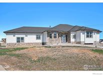 Charming single-story home with stone accents and a well-manicured front yard at 10071 E 142Nd Ave, Brighton, CO 80602