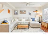 Bright living room with stylish decor, hardwood floors, and large sectional sofa at 1065 Laramie Blvd # F, Boulder, CO 80304