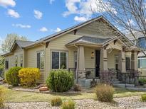 Charming single-story home featuring a welcoming front porch and a beautifully landscaped yard with mature shrubs at 1433 Moonlight Dr, Longmont, CO 80504