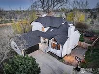 Beautiful two-story home with a modern black and white exterior, spacious driveway, and attached garage at 1540 Sumac Ave, Boulder, CO 80304
