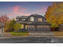 Beautiful two-story home with a three-car garage and manicured lawn at 1579 Hays Ct, Erie, CO 80516