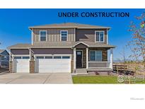 Charming two-story home featuring a stone-accented facade, covered porch and a two car garage at 1898 Westport Ave, Berthoud, CO 80513