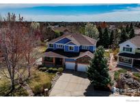 Beautiful two-story home with blue siding, stone accents, and a well-maintained yard at 2000 Prestwick Ct, Longmont, CO 80504
