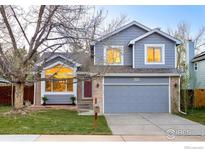Charming two-story home featuring a brick facade, well-manicured lawn, and attached two-car garage at 221 S Lark Ave, Louisville, CO 80027