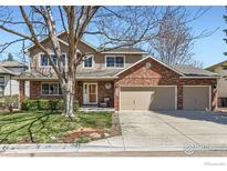 Two-story home with brick and siding, showcasing a well-manicured lawn and attached garage at 3124 Marlin Dr, Longmont, CO 80503