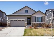 Charming single-Gathering home featuring a well-manicured lawn and an attached two-car garage at 450 Pikes View Dr, Erie, CO 80516