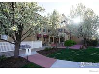 Charming building exterior with meticulous landscaping and trees blooming in spring at 4500 Baseline Rd # 4104, Boulder, CO 80303