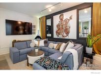 Comfortable living area with sectional sofa, TV, and contemporary decor at 801 Confidence Dr # 2, Longmont, CO 80504
