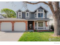 Charming two-story home featuring a brick facade, attached two-car garage, and a beautifully landscaped front yard at 918 E 132Nd Ave, Thornton, CO 80241