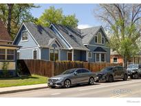 Charming two-story home featuring blue siding, well-maintained landscaping, and a welcoming facade at 1605 17Th St, Boulder, CO 80302