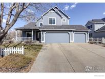 Charming two-story home featuring a spacious three car garage and welcoming front porch at 2547 Concord Cir, Lafayette, CO 80026