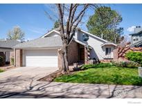 Charming home features a manicured lawn and a two-car garage, creating an inviting curb appeal at 3333 E Florida Ave # 129, Denver, CO 80210