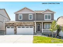 Charming two-story home with a three car garage and stone accents on the lower level at 4202 Sandstone Dr, Mead, CO 80504