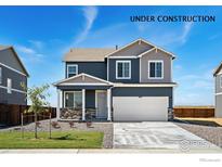 Charming two-story home boasts a two-car garage and a beautifully landscaped front yard at 4202 Sandstone Dr, Mead, CO 80504