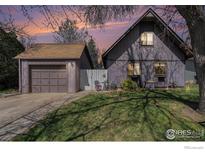 Charming home featuring a detached garage, cozy front yard, and inviting curb appeal with a small patio set at 114 Placer Ave, Longmont, CO 80504