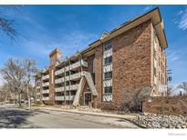 Brick apartment building with balconies, trimmed walkways and a view of the surrounding neighborhood at 1366 Garfield St # 209, Denver, CO 80206
