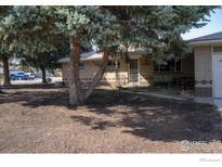 Charming brick home with mature trees and a well-maintained front yard at 2071 W 54Th Pl, Denver, CO 80221