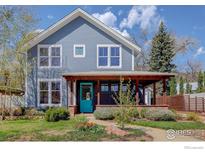 Charming two-story home featuring a covered front porch and vibrant turquoise front door at 3021 Jefferson St, Boulder, CO 80304