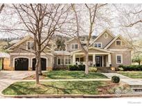 Charming craftsman-style home with a covered front porch, beautiful lawn, and mature trees at 3189 5Th St, Boulder, CO 80304